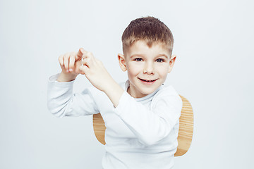 Image showing little cute adorable boy posing gesturing cheerful on white background, lifestyle people concept closeup