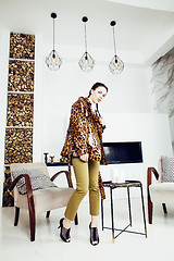 Image showing pretty stylish woman in fashion dress with leopard print together in luxury rich room interior, lifestyle people concept, modern brunette together