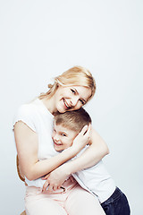 Image showing young modern blond curly mother with cute son together happy smiling family posing cheerful on white background, lifestyle people concept, sister and brother friends