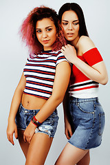 Image showing lifestyle people concept: two pretty stylish modern hipster teen girl having fun together, diverse nation mixed races, happy smiling making selfie closeup