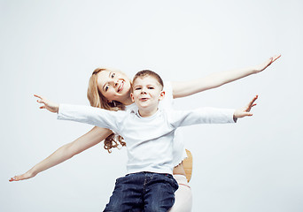 Image showing young modern blond curly mother with cute son together happy smiling family posing cheerful on white background, lifestyle people concept, sister and brother friends