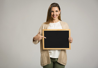 Image showing Woman showing something on a chalkboard