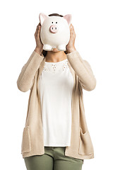 Image showing Woman holding piggybank