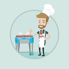 Image showing Man cooking steak on gas barbecue grill.