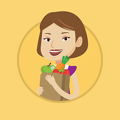 Image showing Happy woman holding grocery shopping bag.