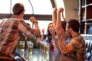 Image showing football fans or friends with beer at sport bar