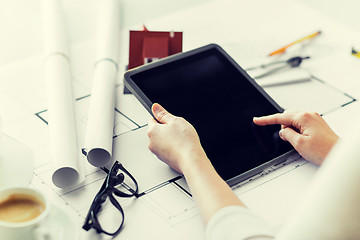 Image showing close up of hand with blueprint and tablet pc