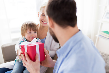 Image showing happy family with birthday gift at home