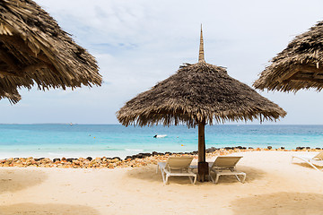 Image showing palapa and sunbeds on exotic tropical beach