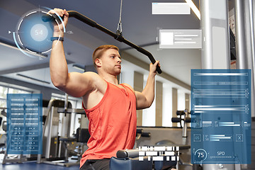 Image showing man flexing muscles on cable machine gym