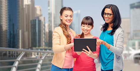 Image showing international happy women with tablet pc in city