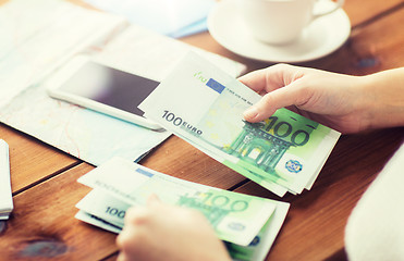 Image showing close up of traveler hands counting euro money