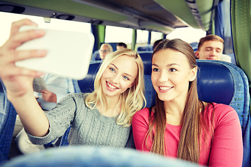 Image showing women taking selfie by smartphone in travel bus