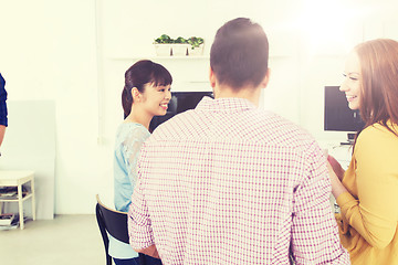 Image showing happy creative team talking at office