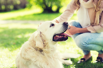 Image showing close up of woman with labrador dog on walk