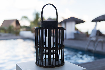 Image showing lantern with candle at outdoor swimming pool