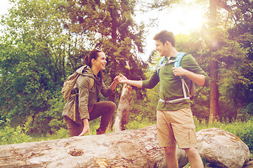 Image showing smiling couple with backpacks hiking