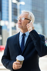 Image showing senior businessman calling on smartphone in city