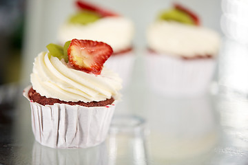 Image showing cupcake with cream and strawberry at sweet shop