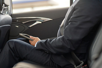 Image showing senior businessman with tablet pc driving in car