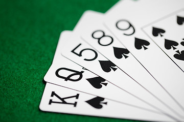 Image showing poker hand of playing cards on green casino cloth