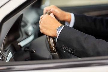 Image showing senior businessman hands driving car