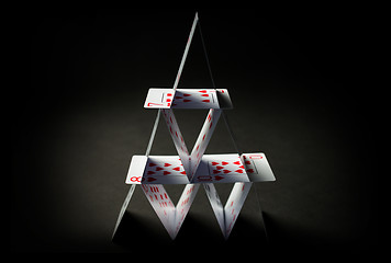 Image showing house of playing cards over black background