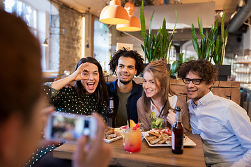 Image showing friends with smartphone photographing at cafe