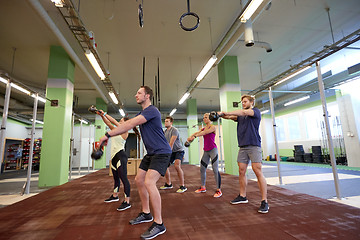 Image showing group of people with kettlebells exercising in gym