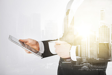 Image showing close up of businessman with tablet pc and coffee