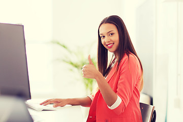 Image showing happy african woman with computer at office