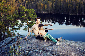 Image showing middle age man with little cute son doing sport yoga on the top of the mountain together, happy family lifestyle people outdoor, summer wild nature for training