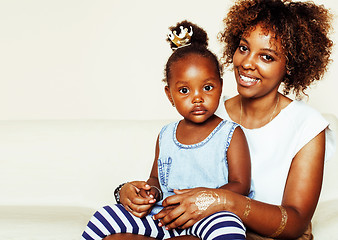 Image showing adorable sweet young afro-american mother with cute little daughter, hanging at home, having fun playing smiling, lifestyle people concept, queen girl