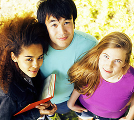 Image showing cute group of teenages at the building of university with books huggings, diversity nations