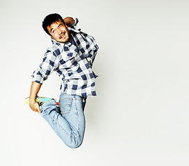 Image showing young pretty asian man jumping cheerful against white background