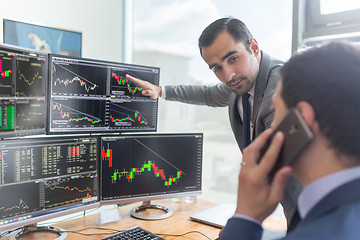 Image showing Stock brokers looking at computer screens, trading online.