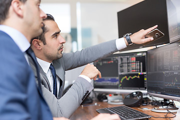Image showing Stock brokers looking at computer screens, trading online.