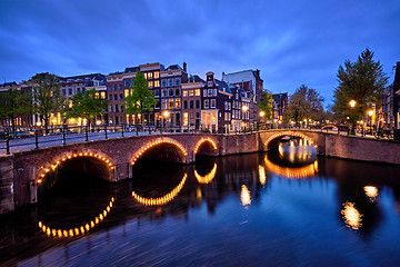 Image showing Amterdam canal, bridge and medieval houses in the evening