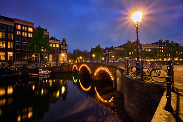 Image showing Amterdam canal, bridge and medieval houses in the evening