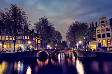 Image showing Amterdam canal, bridge and medieval houses in the evening