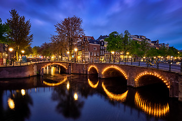 Image showing Amterdam canal, bridge and medieval houses in the evening