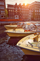 Image showing Amsterdam tourist boats in canal