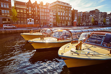 Image showing Amsterdam tourist boats in canal