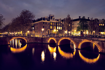 Image showing Amterdam canal, bridge and medieval houses in the evening