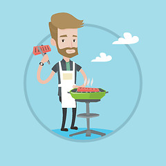 Image showing Man cooking steak on barbecue grill.