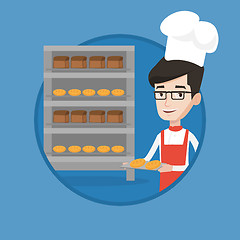 Image showing Happy young male baker holding tray of bread.