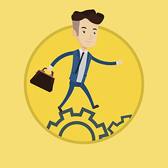 Image showing Businessman running on cogwheels.