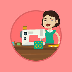 Image showing Seamstress using sewing machine at workshop.