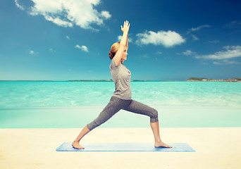 Image showing woman making yoga warrior pose on mat