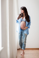 Image showing happy pregnant woman with big tummy at home